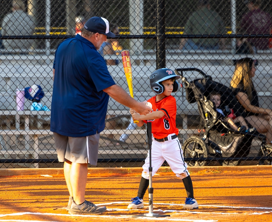 coach with boy and t-ball